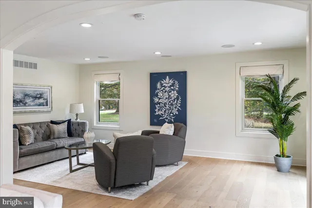 a kitchen with stainless steel appliances a dining table chairs stove and refrigerator