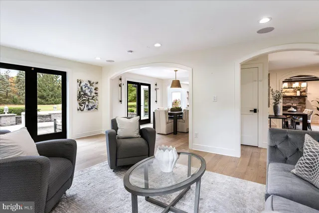 a kitchen with stainless steel appliances a stove a sink dishwasher and a refrigerator with wooden floor