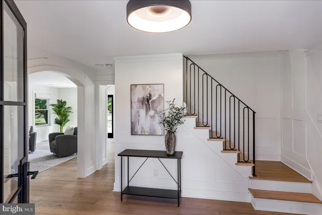 a view of a hallway with wooden floor and entryway