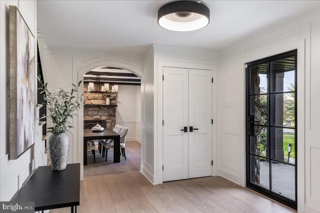 a view of a dining room with furniture a chandelier and wooden floor