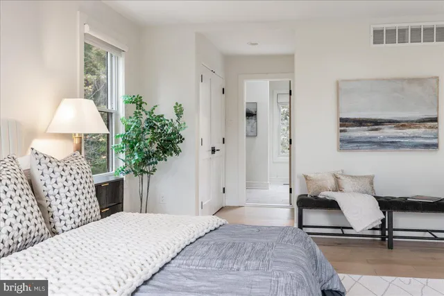 a bedroom with a bed and window