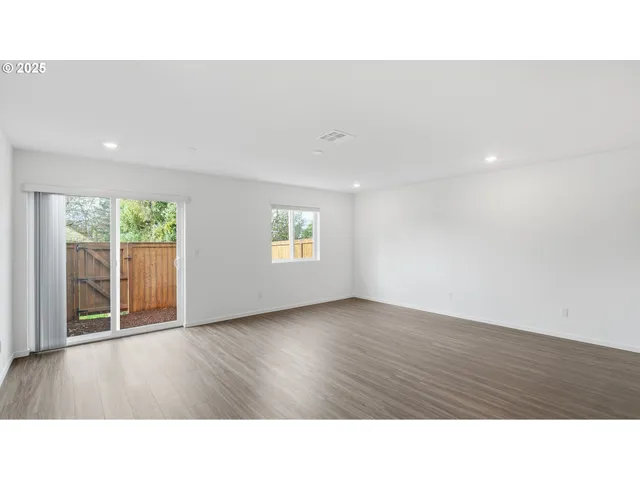 a room with a window and wooden floor