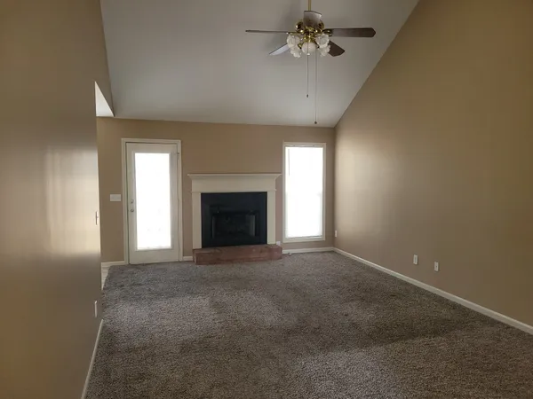 a view of empty room with a fireplace