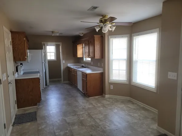 a kitchen with stainless steel appliances granite countertop a sink and a stove