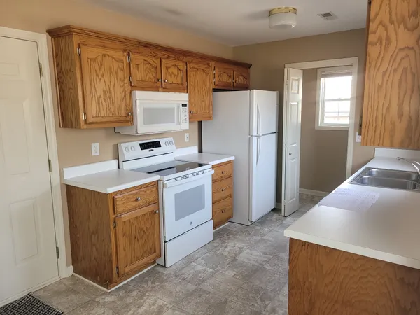 a kitchen with a white cabinets and refrigerator