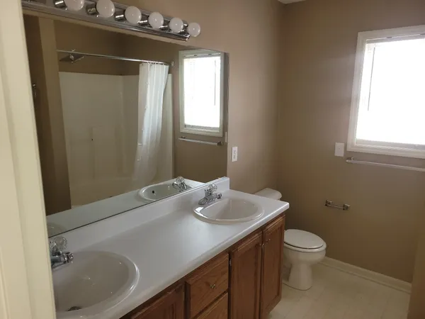 a bathroom with a sink toilet and mirror