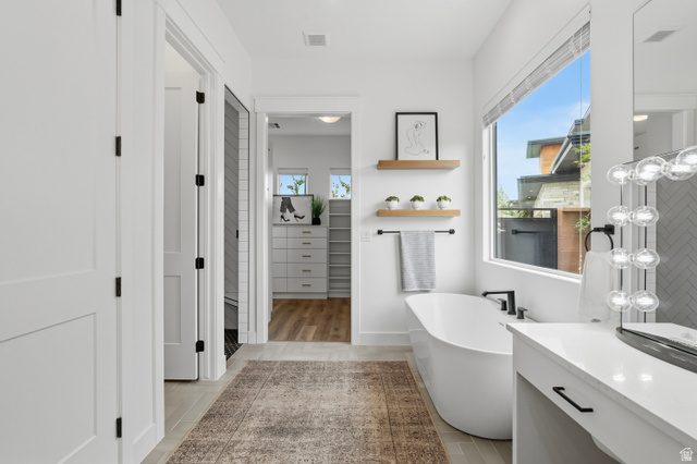 2278 Tawny Ridge Circle St. George, UT 84790 - Photo 25 of 61 Freestanding soaking tub with matte black fixtures, complemented by a large window.