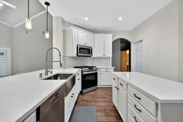 a kitchen with a sink stove and microwave