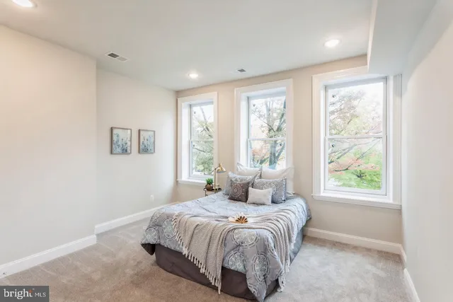 a bedroom with a large bed and a window