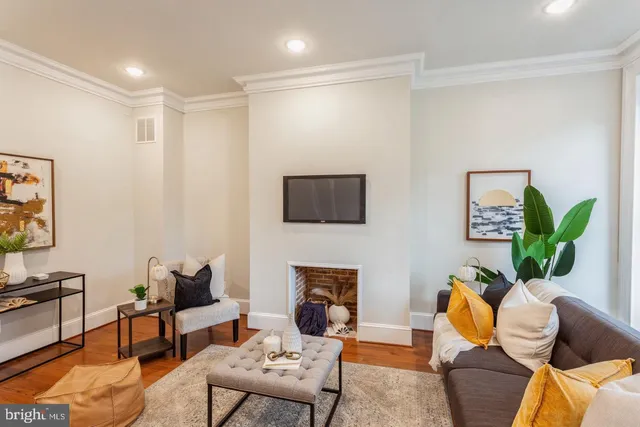 a living room with furniture a couch and a flat screen tv