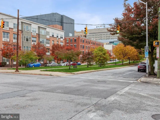 a view of a tall building next to a yard