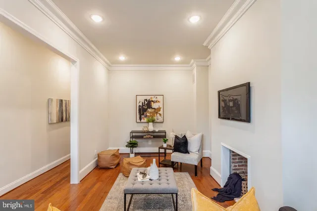 a work room with furniture and a wooden floor