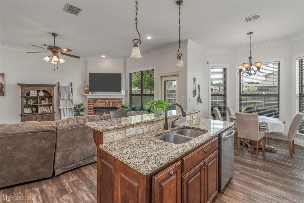 711 Reeds Reef Bossier City, LA 71112 - Photo 10 of 36 a kitchen with granite countertop a table chairs stove and kitchen view