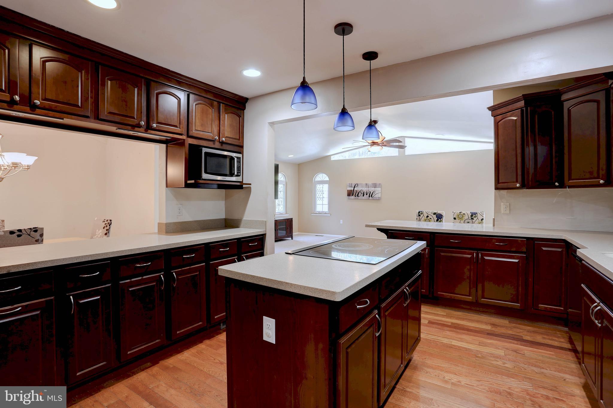 6128 Stevens Forest Road Columbia, MD 21045 - Photo 12 of 44 a kitchen with stainless steel appliances granite countertop a sink stove and cabinets
