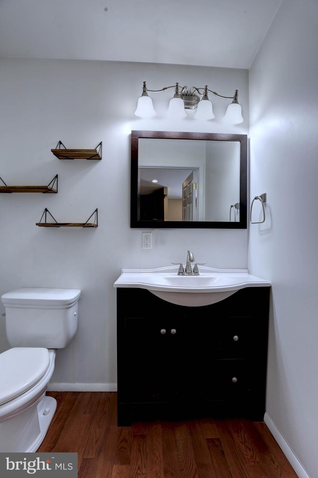6128 Stevens Forest Road Columbia, MD 21045 - Photo 18 of 44 a bathroom with a sink and a mirror