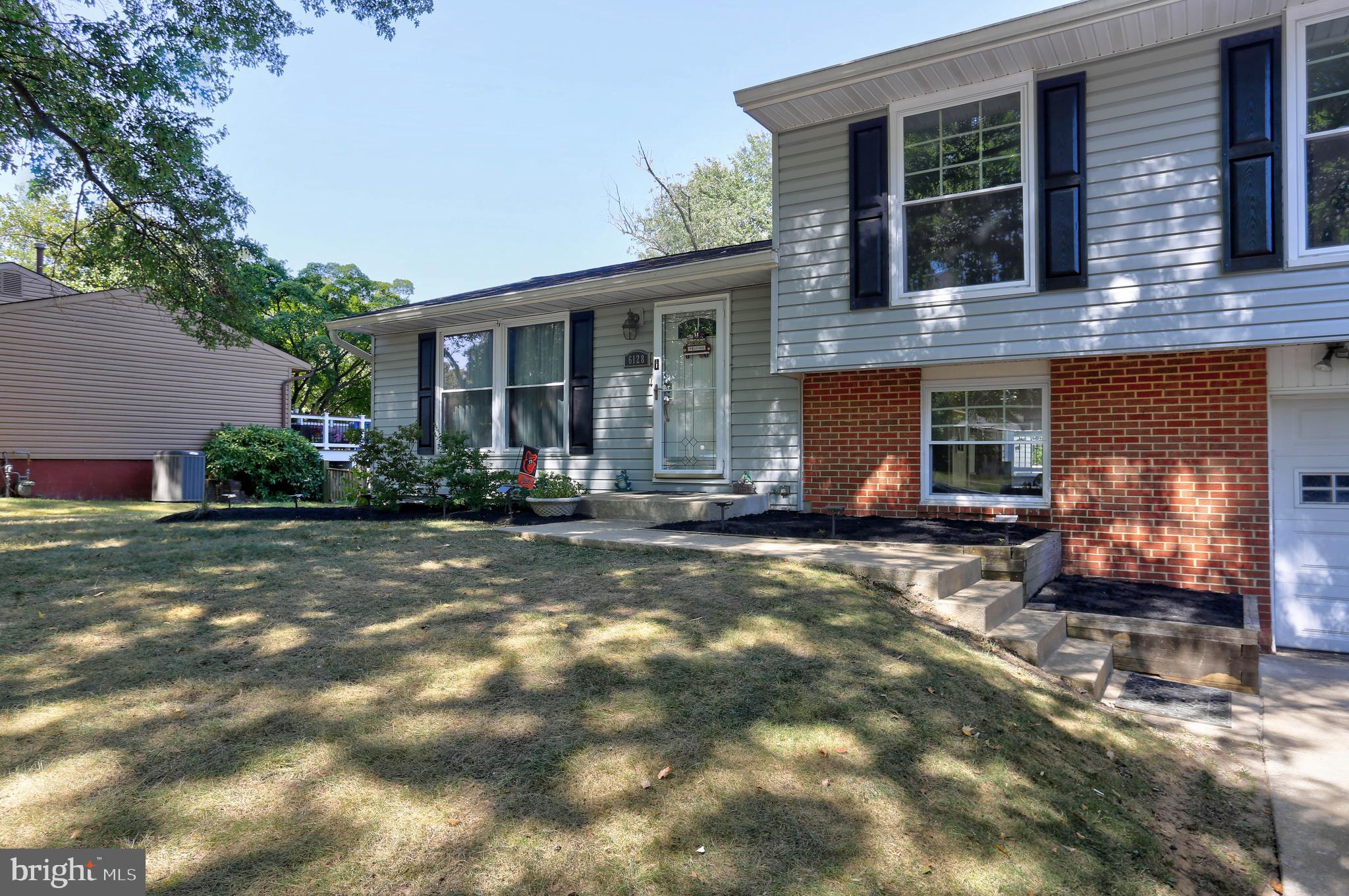 6128 Stevens Forest Road Columbia, MD 21045 - Photo 3 of 44 a front view of a house with a yard