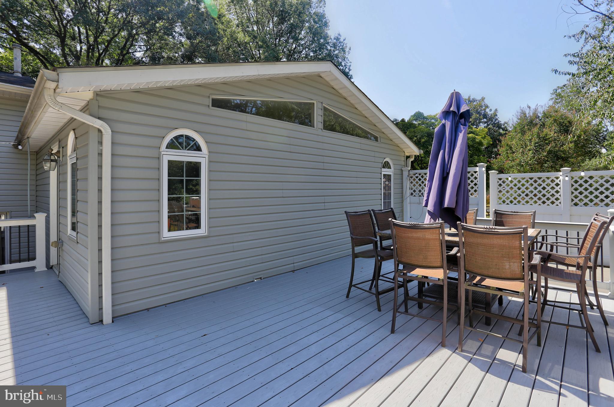 6128 Stevens Forest Road Columbia, MD 21045 - Photo 41 of 44 a view of a patio with table and chairs with wooden floor and fence