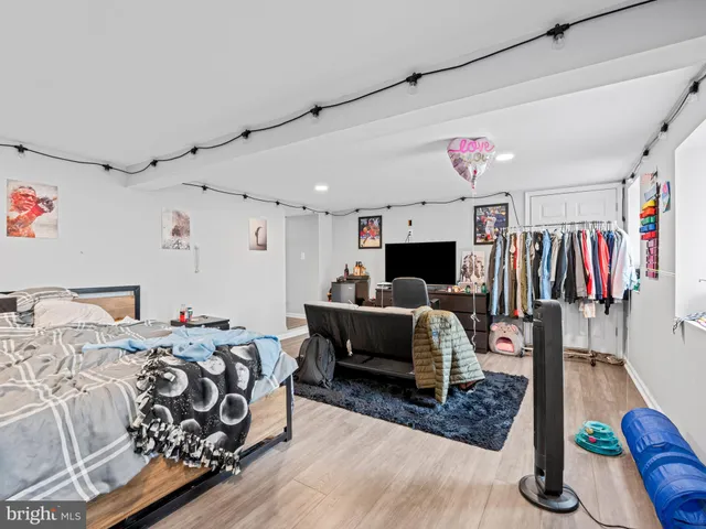 a bedroom with furniture and a flat screen tv