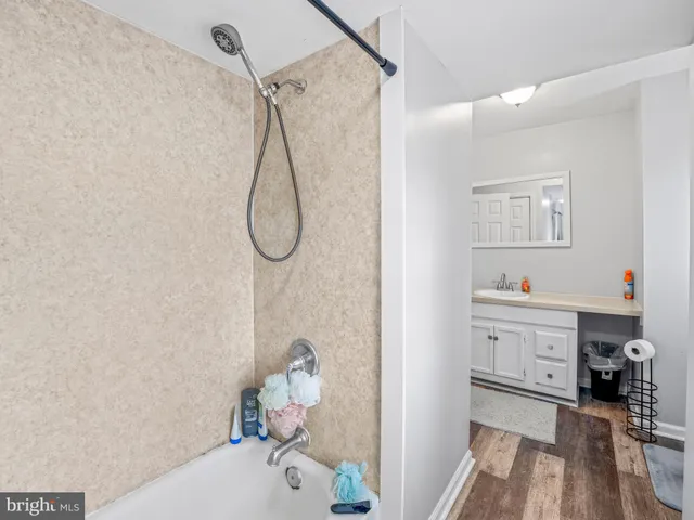 a spacious bedroom with a bed and a chandelier