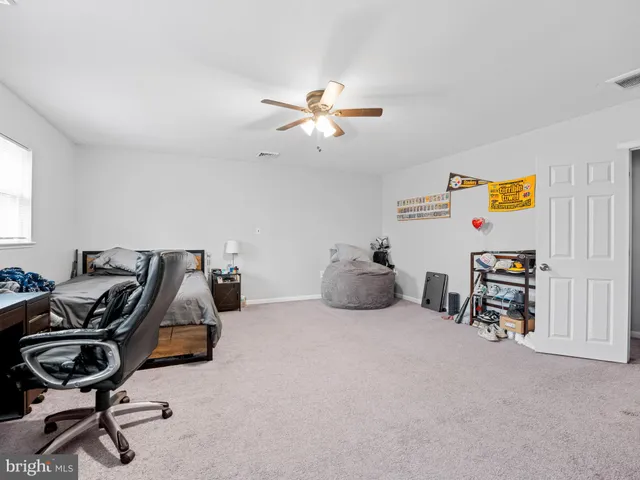 a bedroom with furniture and a mirror