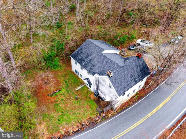 a view of a pool with a lot of flowers in front of it
