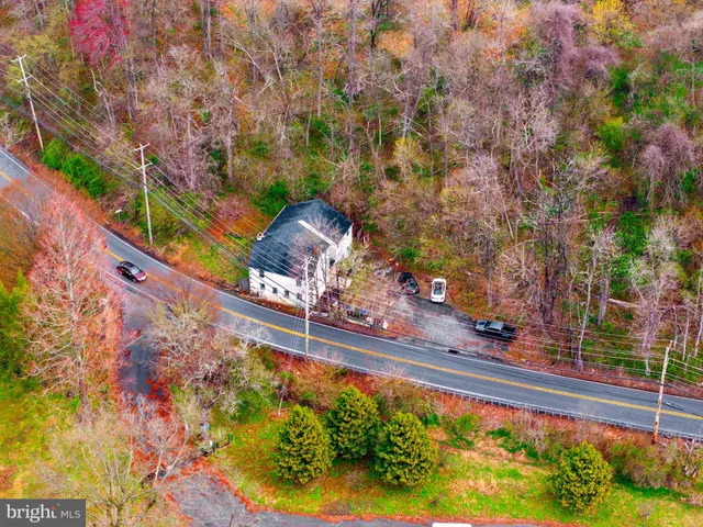 an aerial view of a houses with a swimming pool