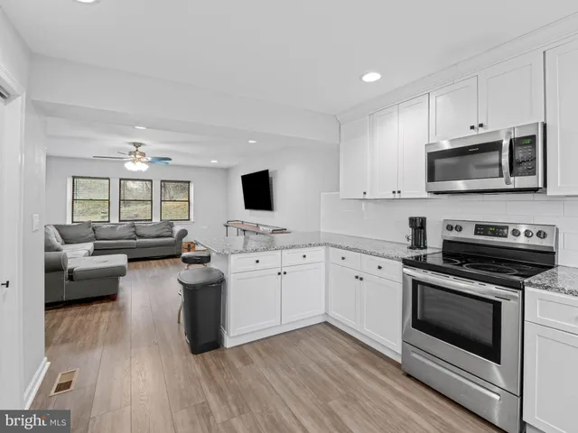 a kitchen with stainless steel appliances a stove microwave and cabinets