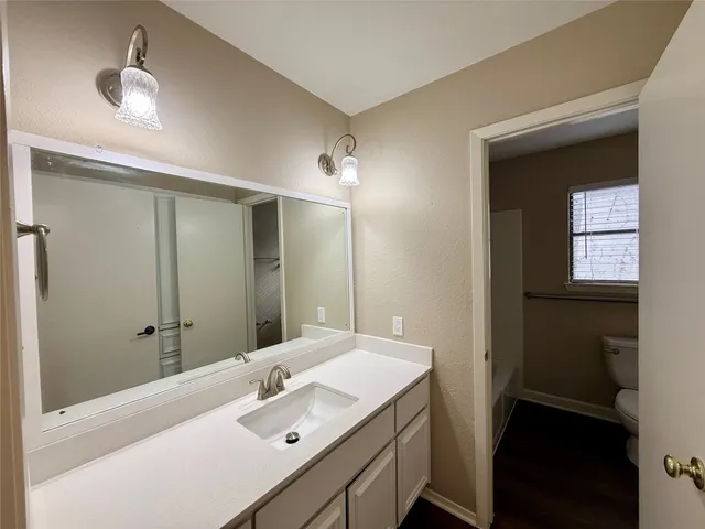 a bathroom with a sink a light fixture and a mirror