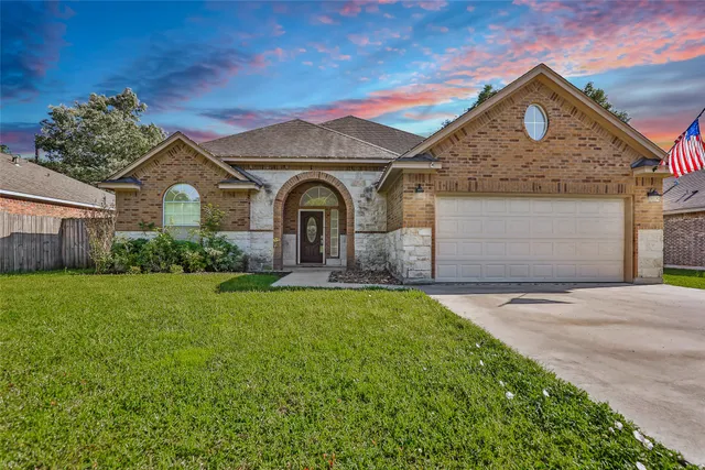 a front view of a house with a yard and garage