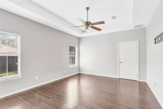 wooden floor in an empty room with a window