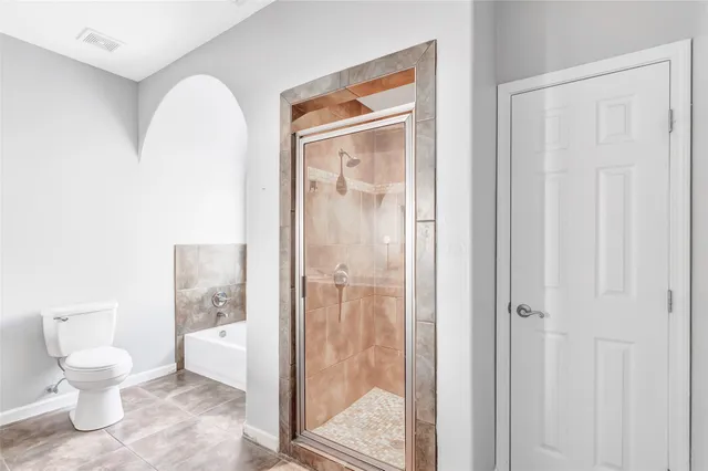 a bathroom that has a glass shower door