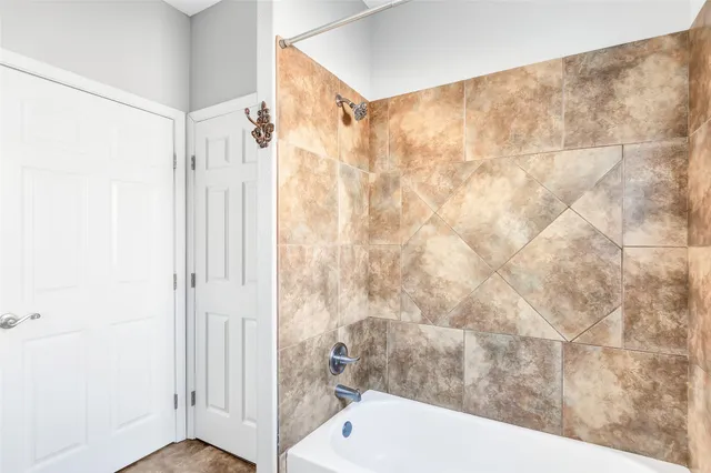 a bathroom with a shower and a sink