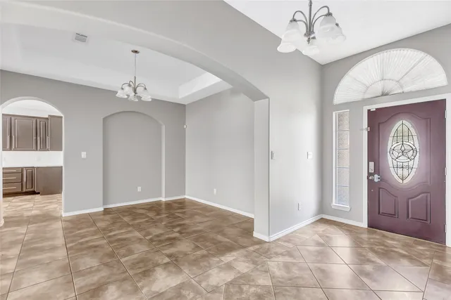 a view of an entryway with a chandelier
