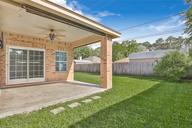 a view of a house with backyard and porch
