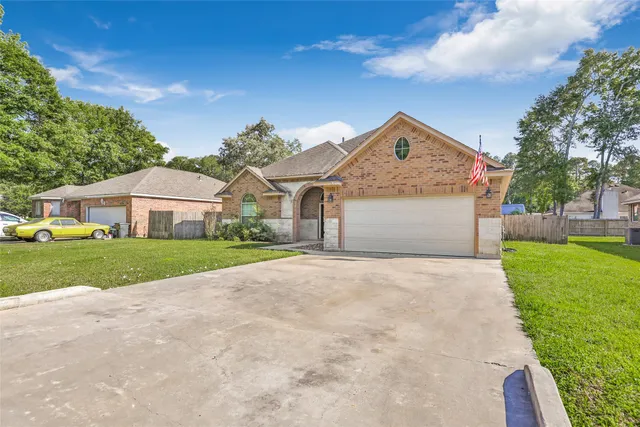 a front view of house with yard and green space