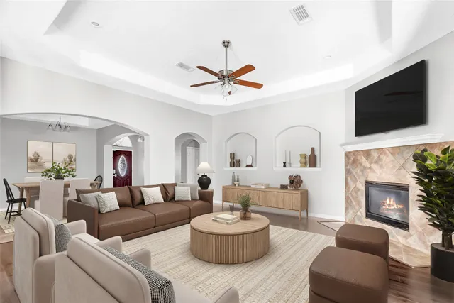 a living room with furniture a fireplace and a flat screen tv