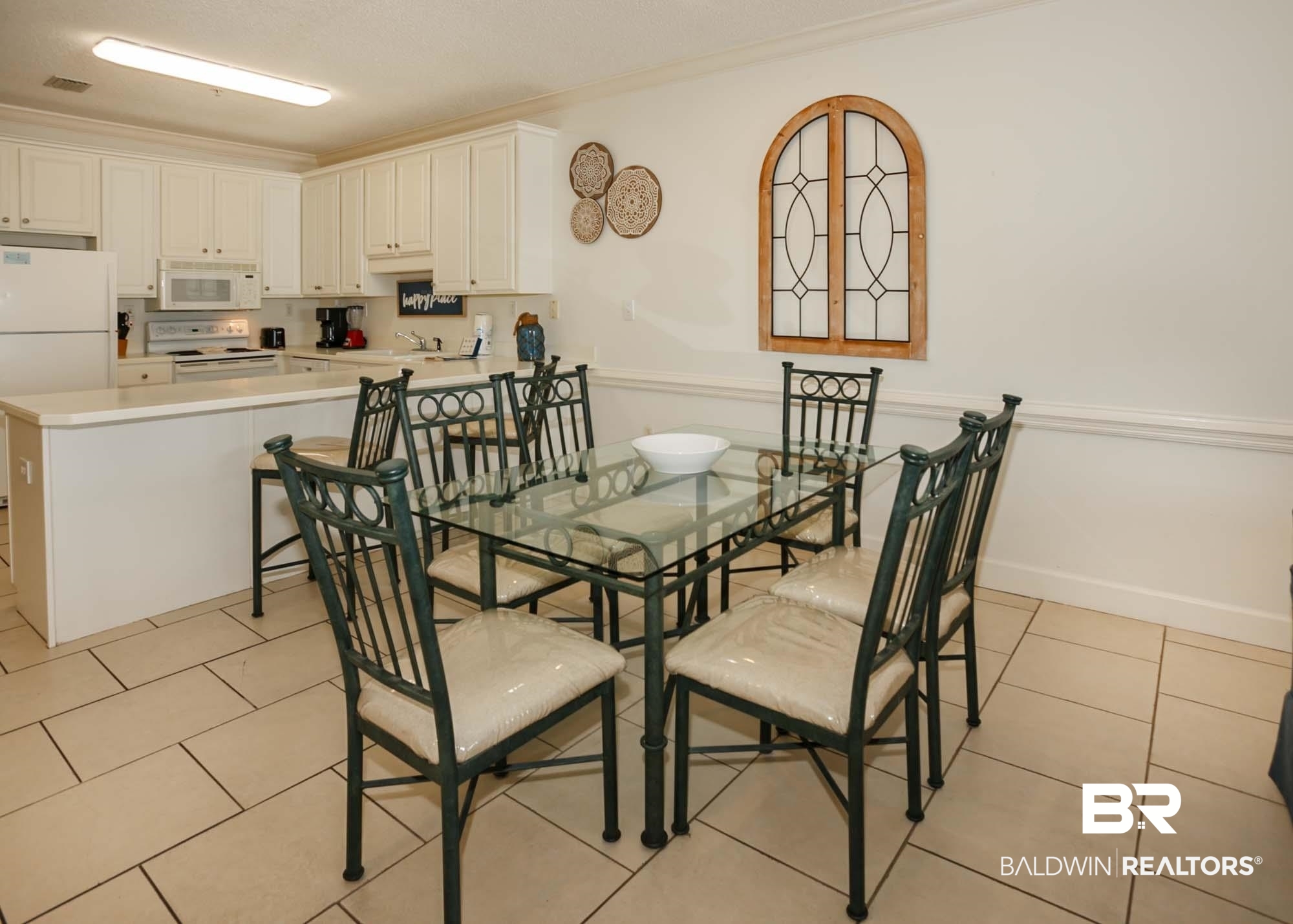 28910 Perdido Beach Boulevard, Unit 4B Orange Beach, AL 36561 - Photo 10 of 48 Dining room featuring light tile patterned floors, crown molding, and baseboards