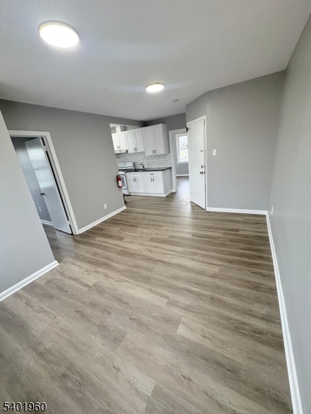 37 Mercer Street, Unit 4 Wallington, NJ 07057 - Photo 3 of 11 a view of empty room with wooden floor
