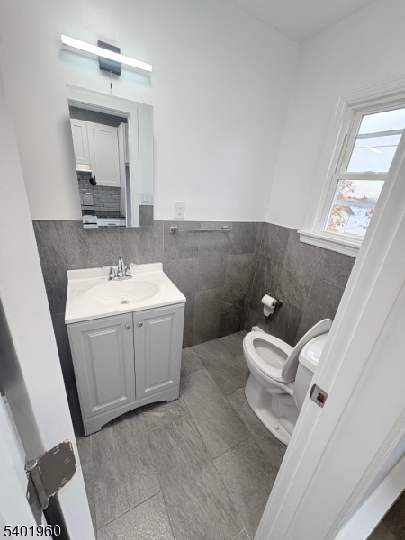 37 Mercer Street, Unit 4 Wallington, NJ 07057 - Photo 5 of 11 a bathroom with a sink toilet and mirror