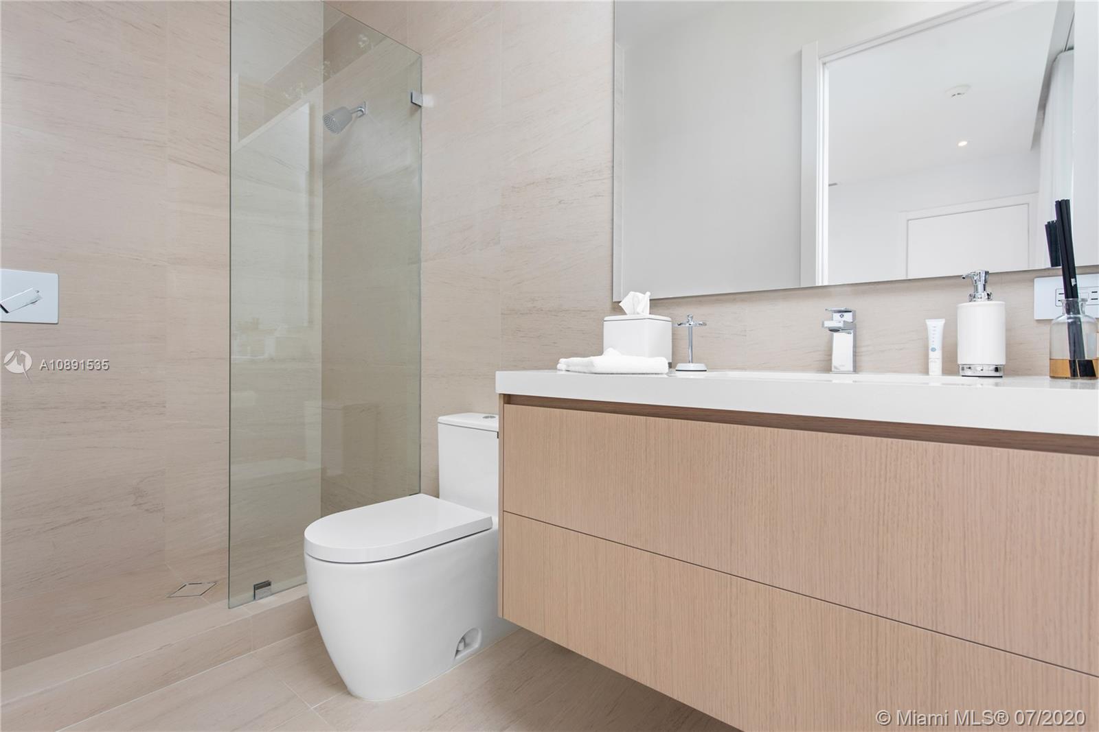 Sunset Islands Miami Beach, FL 33140 - Photo 25 of 72 a bathroom with a sink a toilet and a mirror