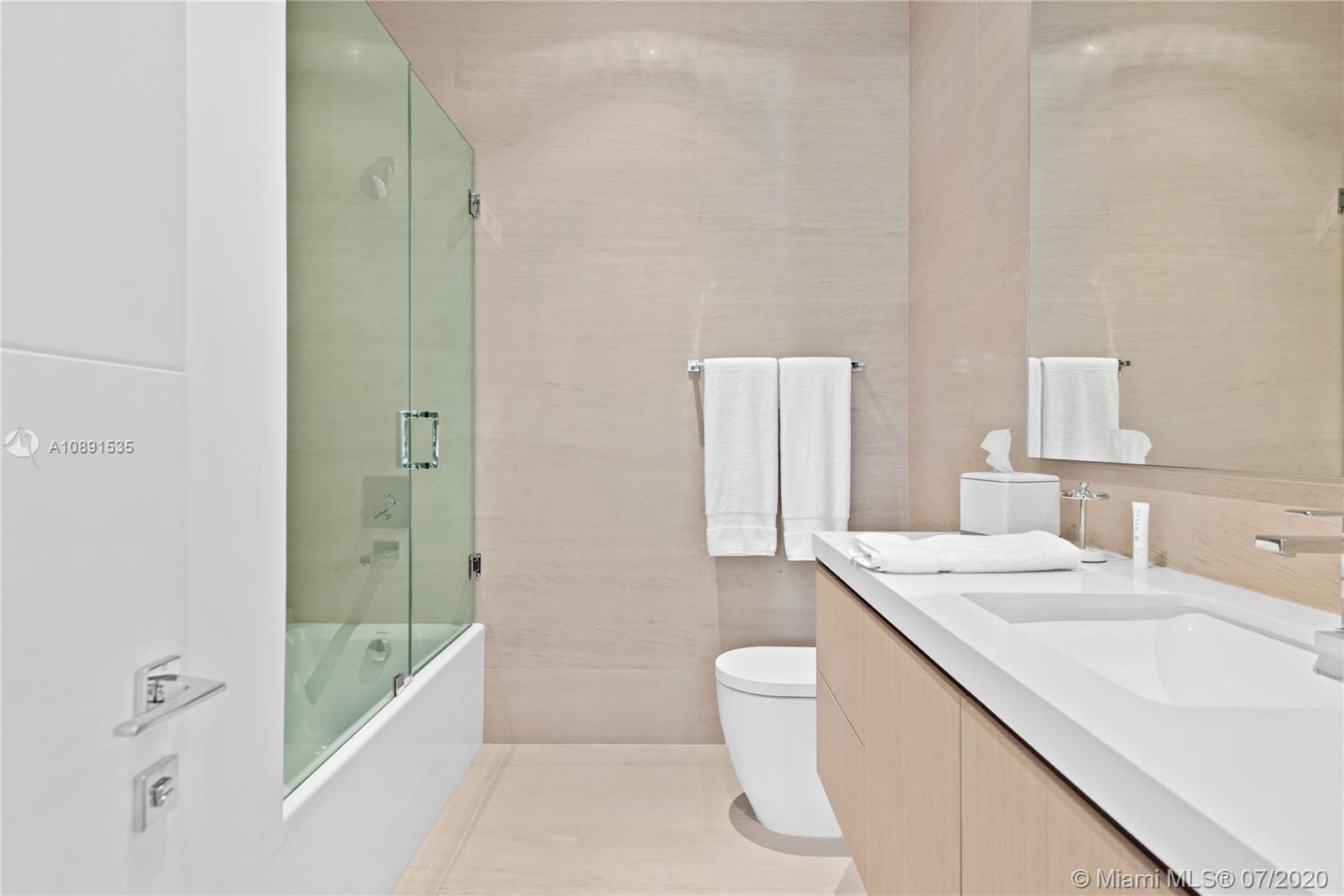 Sunset Islands Miami Beach, FL 33140 - Photo 36 of 72 a bathroom with a granite countertop sink a toilet and shower