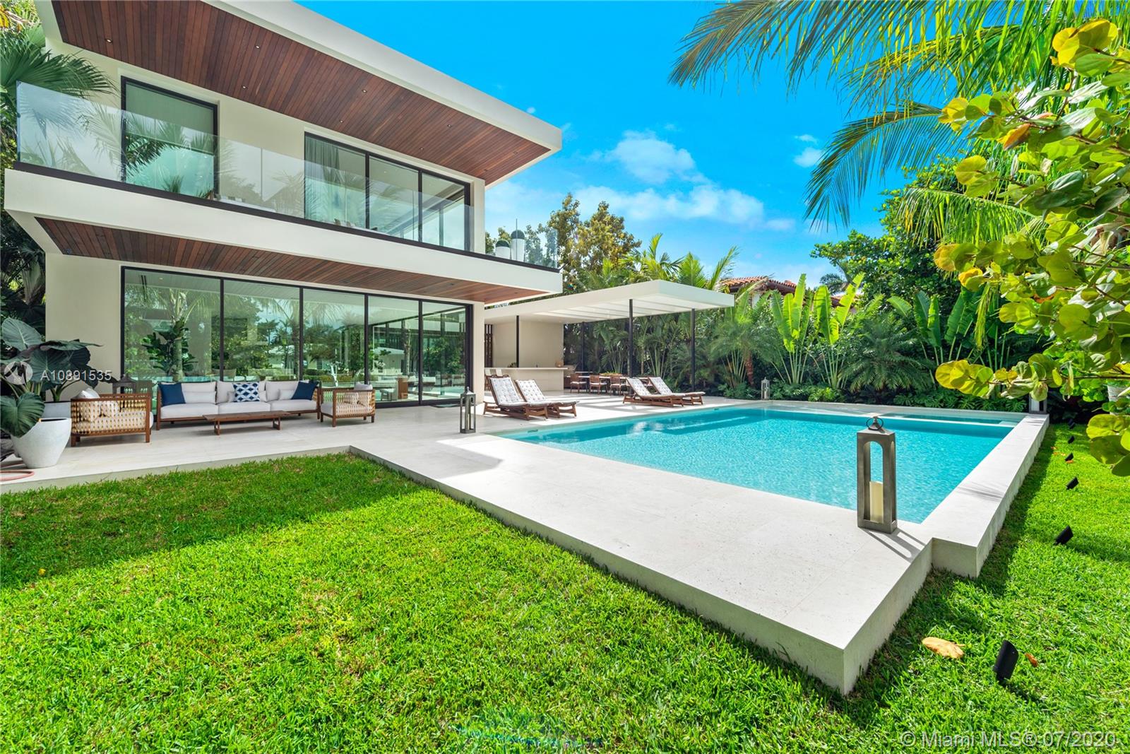Sunset Islands Miami Beach, FL 33140 - Photo 4 of 72 a view of a patio with a table and chairs under an umbrella