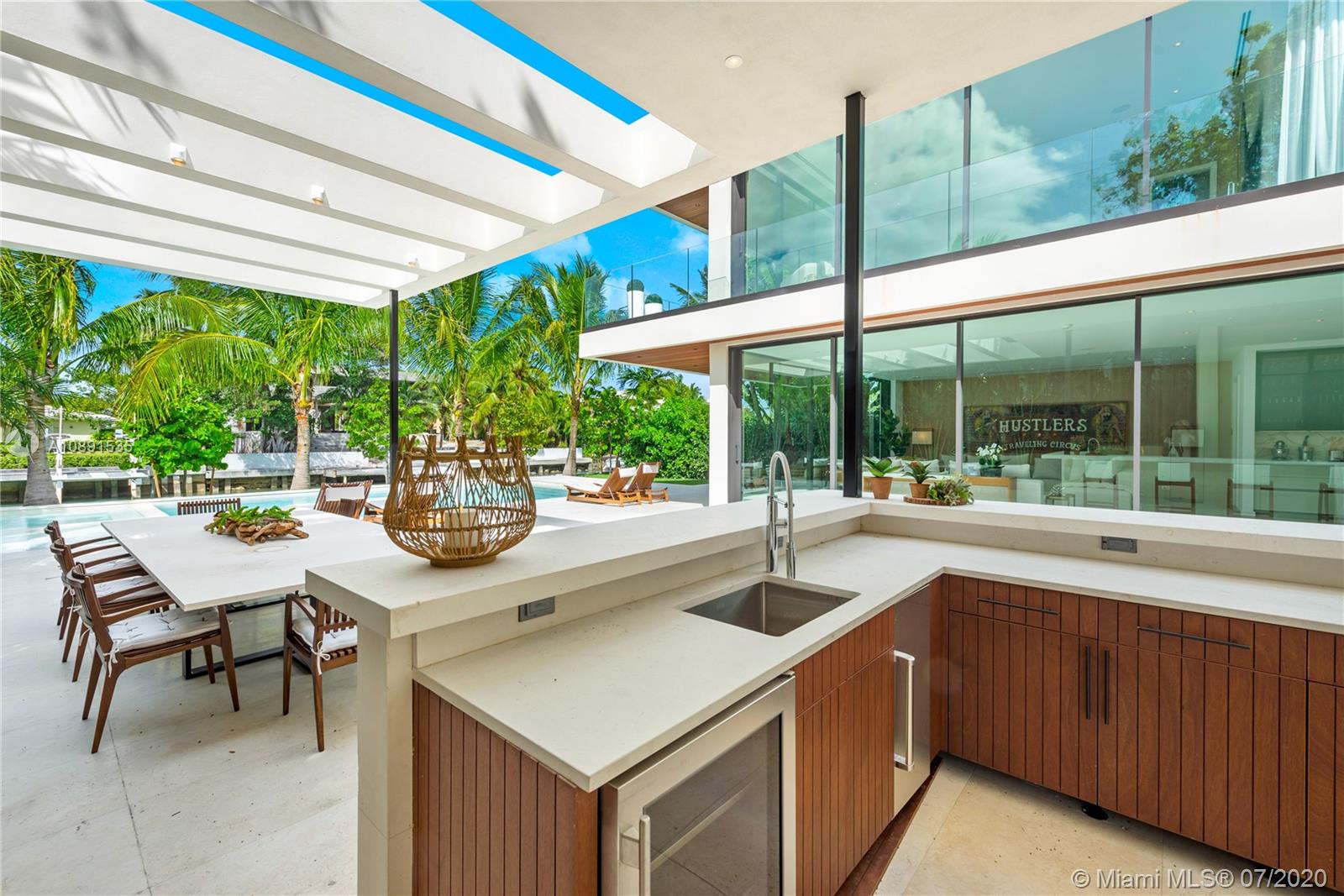 Sunset Islands Miami Beach, FL 33140 - Photo 8 of 72 a view of a patio with a table and chairs under an umbrella