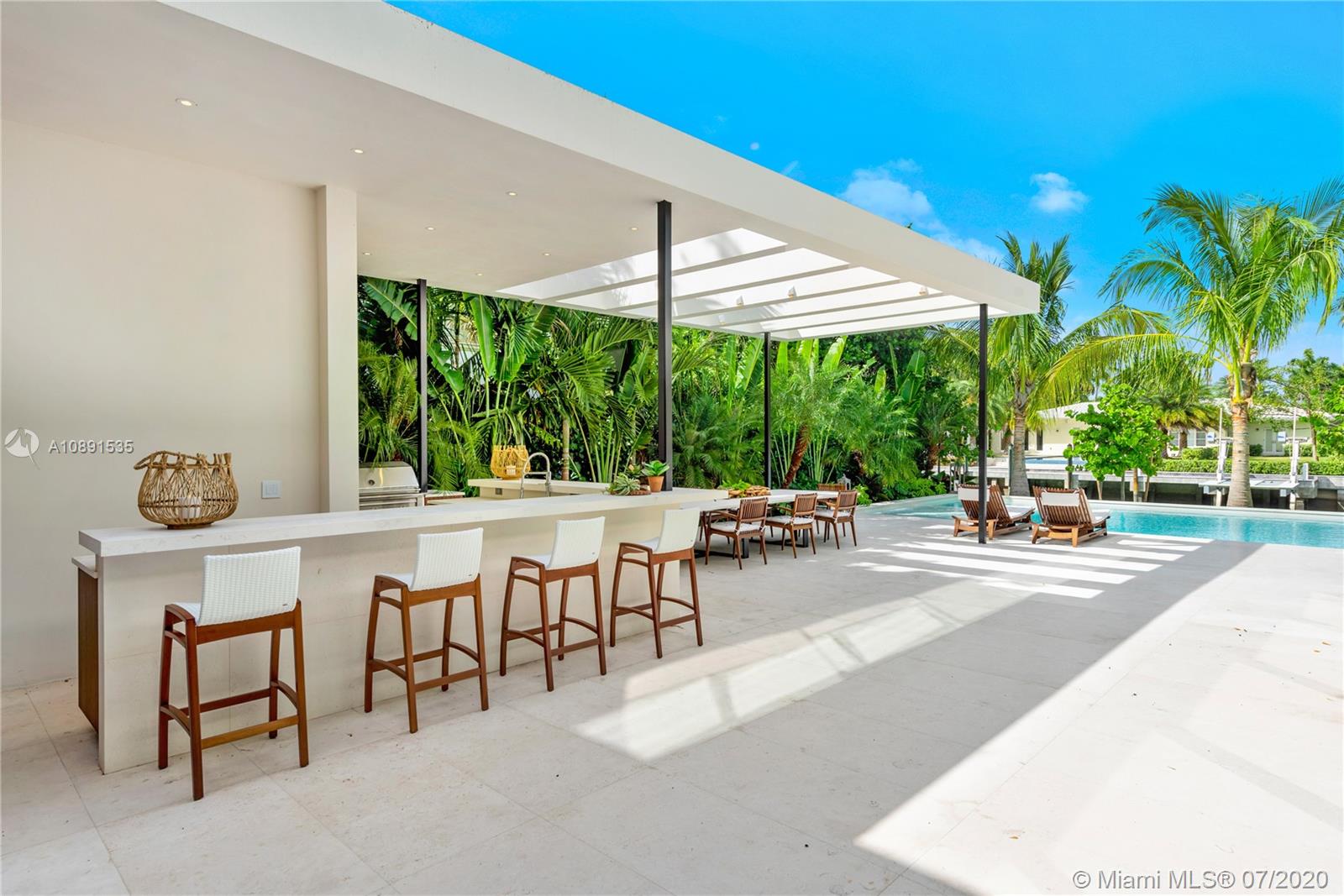 Sunset Islands Miami Beach, FL 33140 - Photo 9 of 72 a view of a patio with a table and chairs under an umbrella