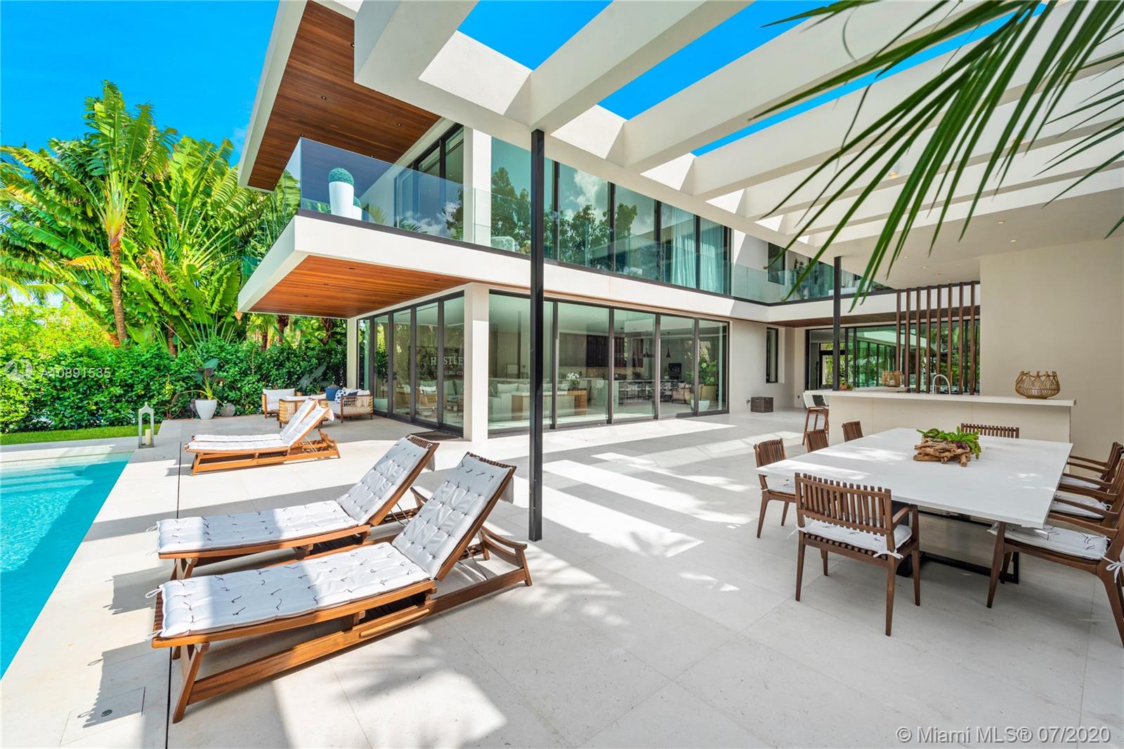 Sunset Islands Miami Beach, FL 33140 - Photo 10 of 72 a view of a patio with a table and chairs under an umbrella