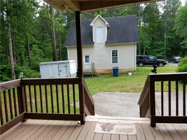 a front view of a house with yard porch and green space