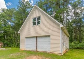 a view of a house with a yard and sitting area