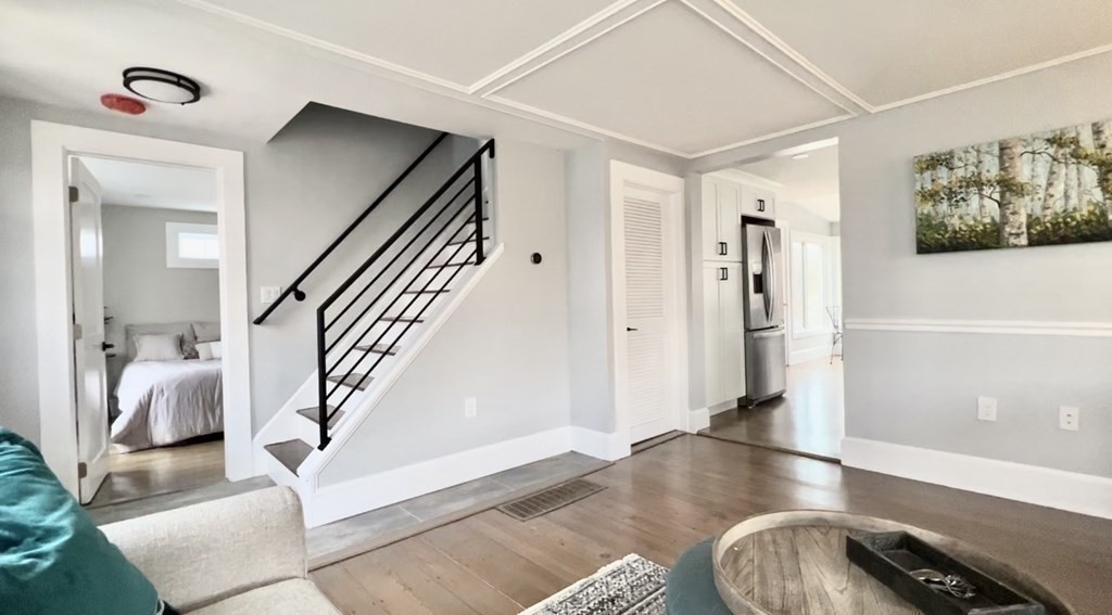 17 Andrews Street Danvers, MA 01923 - Photo 3 of 42 a view of a hallway to a livingroom with wooden floor and furniture