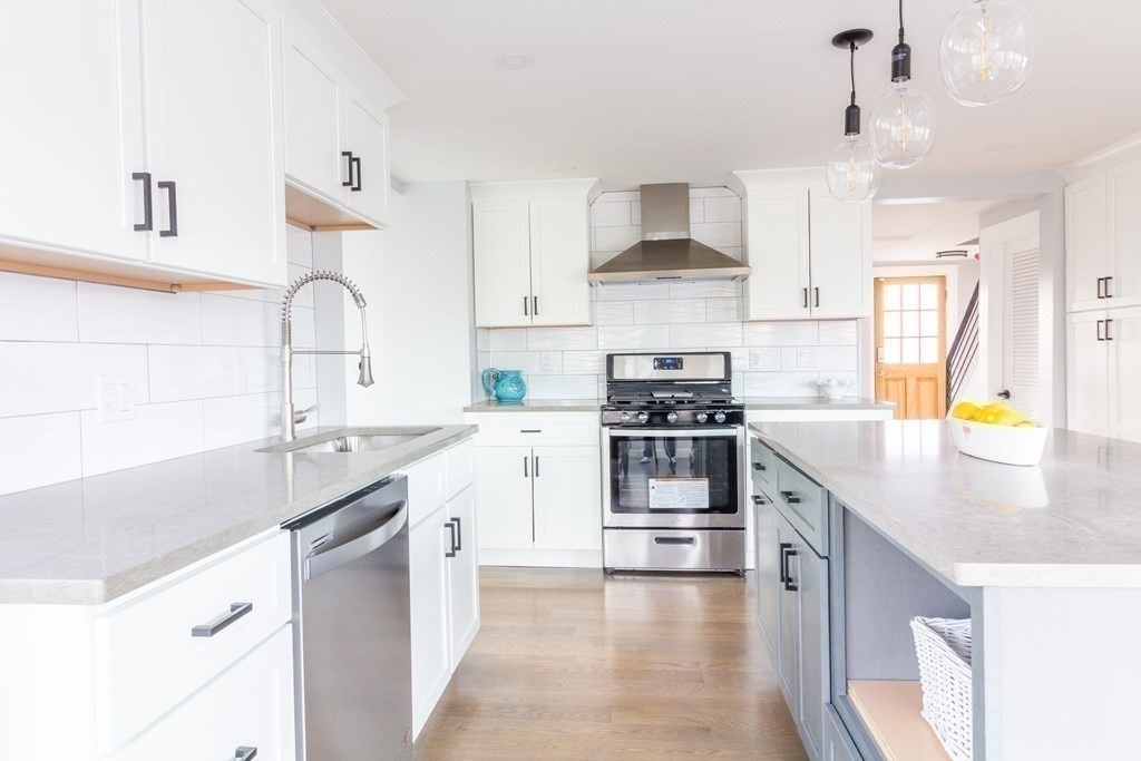 17 Andrews Street Danvers, MA 01923 - Photo 6 of 42 a kitchen with stainless steel appliances a sink stove and cabinets