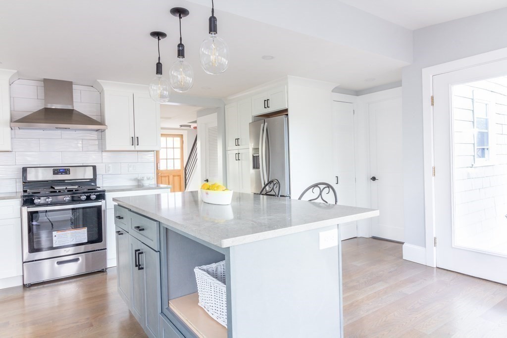 17 Andrews Street Danvers, MA 01923 - Photo 8 of 42 a kitchen with stainless steel appliances granite countertop a sink a stove and a refrigerator